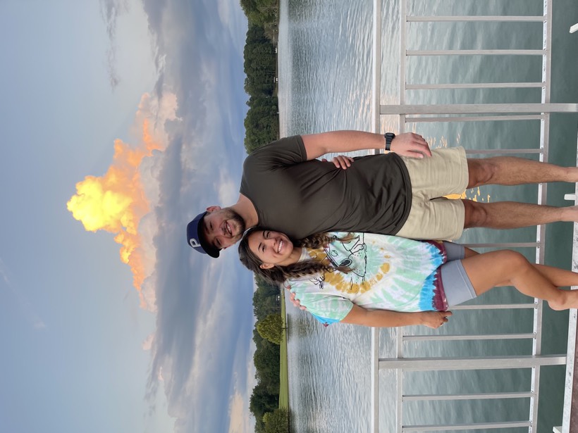 Chazlyn and Nicolas by a lake at sunset