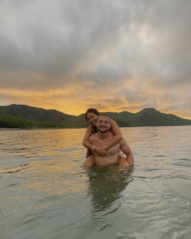 Chazlyn and Nicolas in the water at sunset